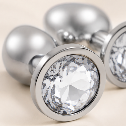 Close-up van het heldere kristal en de gepolijste zilveren afwerking van de FlexToyz buttplug set