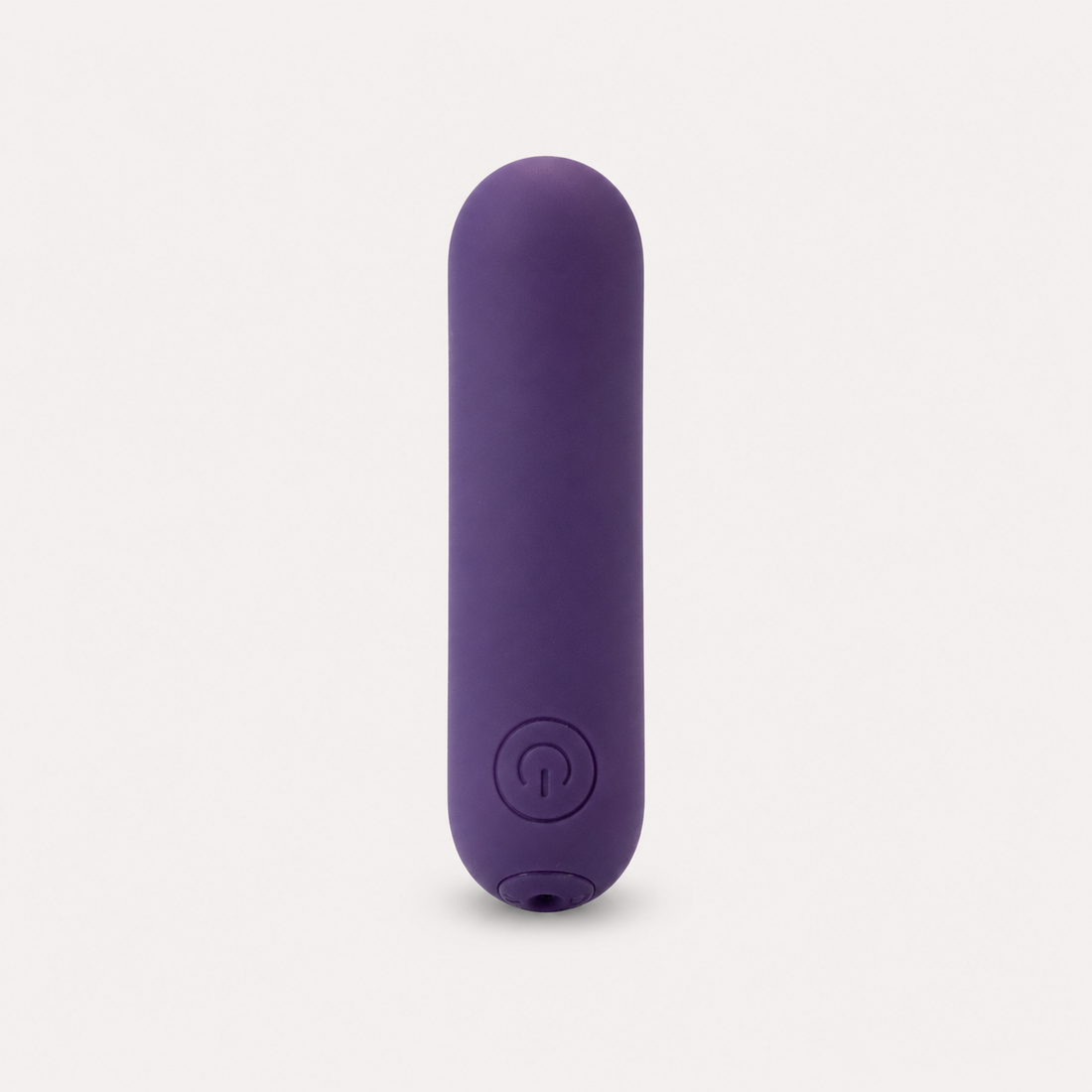 FlexToyz paarse bullet vibrator met ronde powerknop op neutrale studioachtergrond
