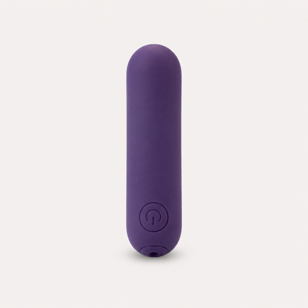 FlexToyz paarse bullet vibrator met ronde powerknop op neutrale studioachtergrond