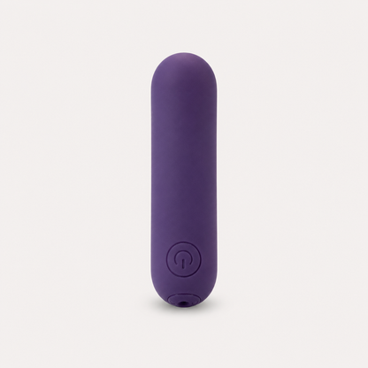 FlexToyz paarse bullet vibrator met ronde powerknop op neutrale studioachtergrond
