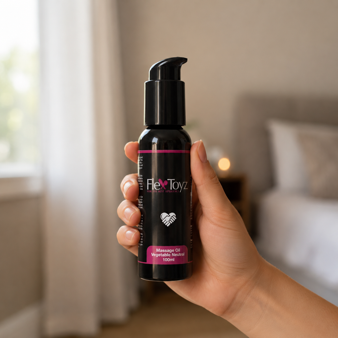 Hand houdt zwarte 100 ml flacon FlexToyz vegan massageolie voor duidelijke schaalweergave